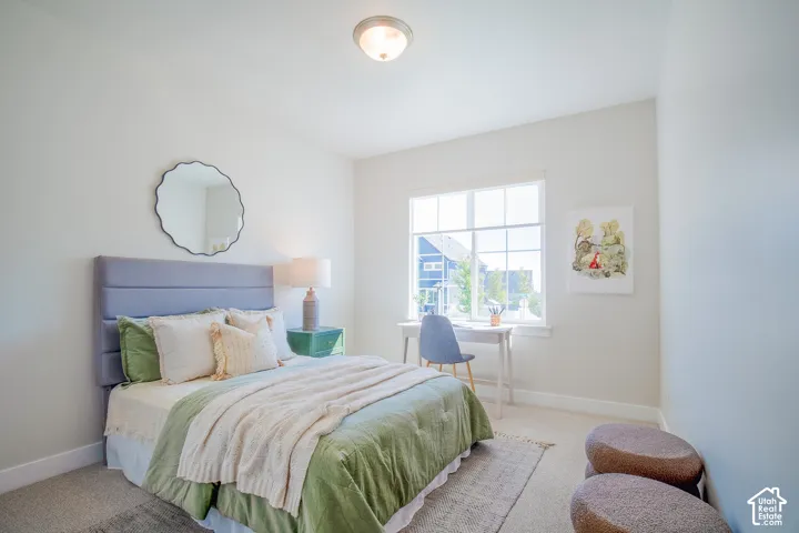 Wall-to-wall carpeting with a large window, flush mount ceiling light, and light-colored walls