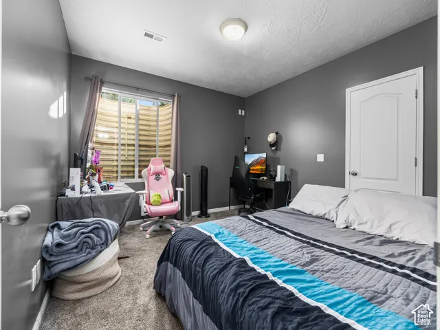 Carpeted room featuring a white interior door with paneling, a recessed window, and neutral gray wall paint