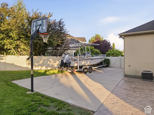 Outdoor recreational area featuring a basketball hoop with a clear backboard