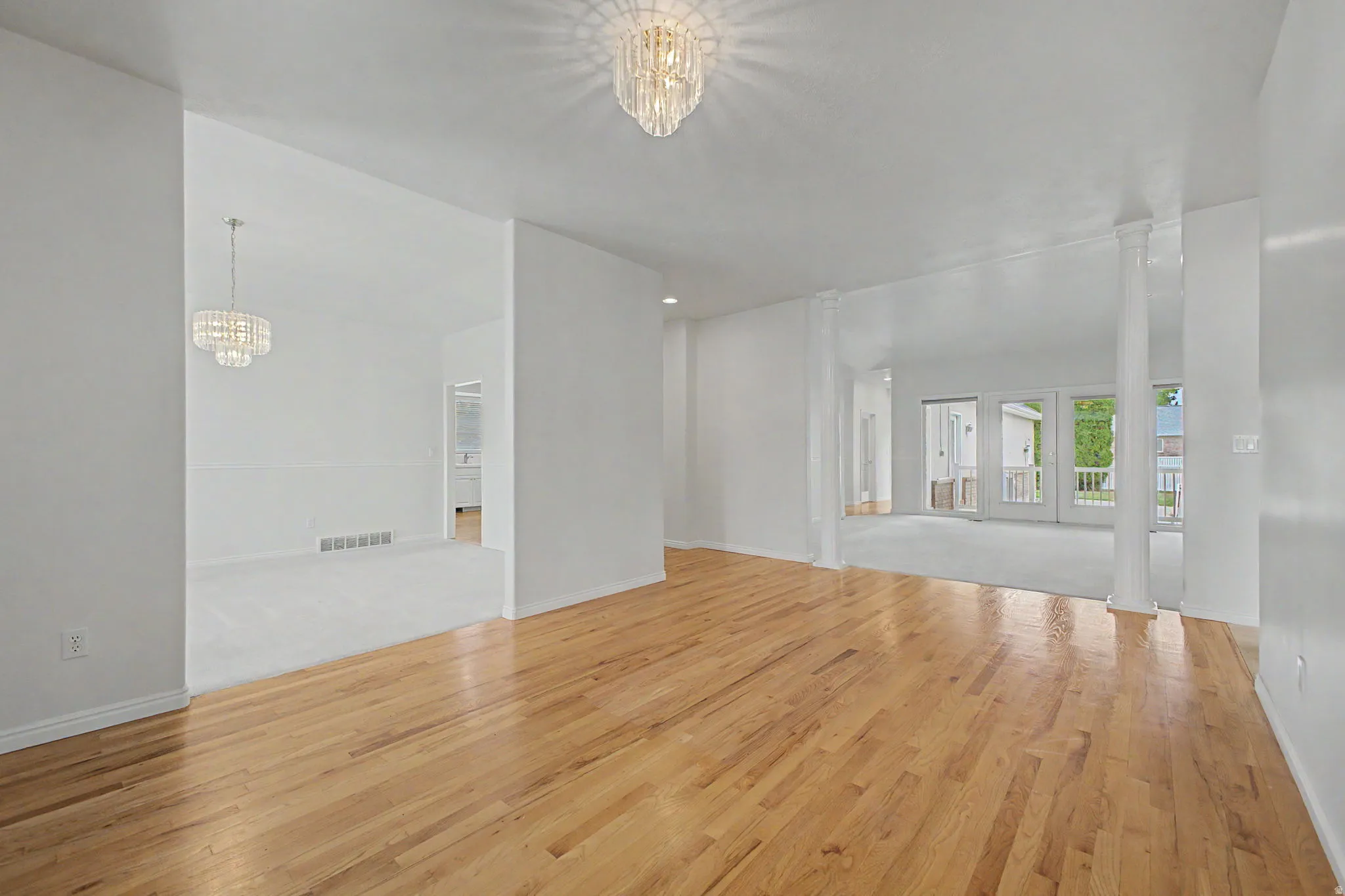 Light wood-finish flooring extending into a spacious area
