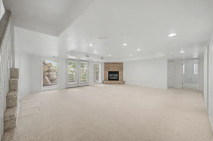 Spacious interior with neutral carpeting and recessed lighting