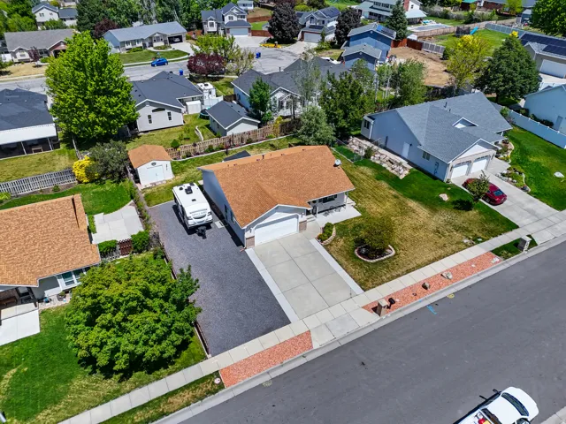 Single-story residence with a two-car garage and an extended gravel driveway