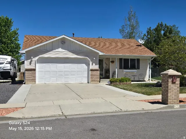 Traditional single-story residence featuring a two-car garage with a panel door
