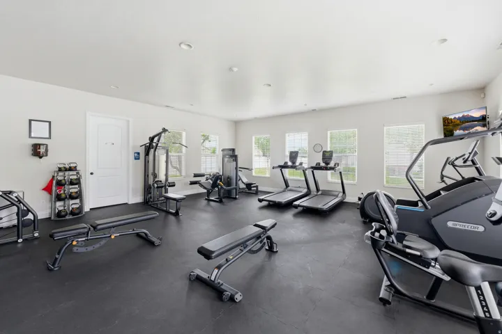 In Club House Spacious fitness room featuring rubberized flooring, abundant natural light from multiple windows, and recessed lighting