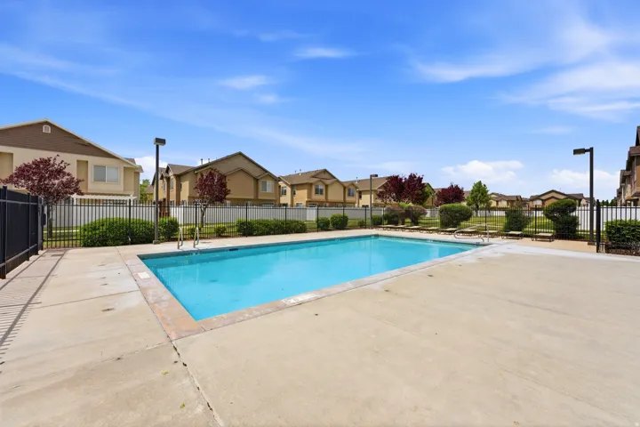 Rectangular outdoor swimming pool with a concrete surround