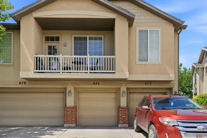 Multi-story exterior with stucco siding and shingle accents