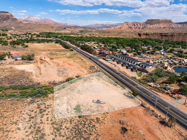 Expansive triangular-shaped parcel featuring direct road frontage and a rugged, natural landscape