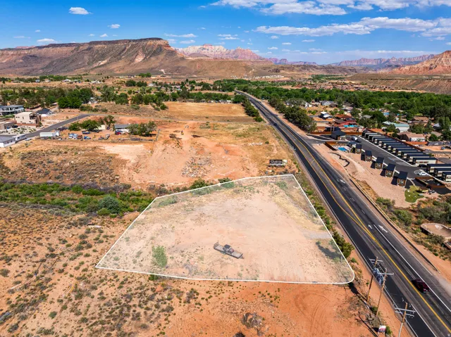 Expansive land parcel featuring direct road frontage and distant mountain scenery
