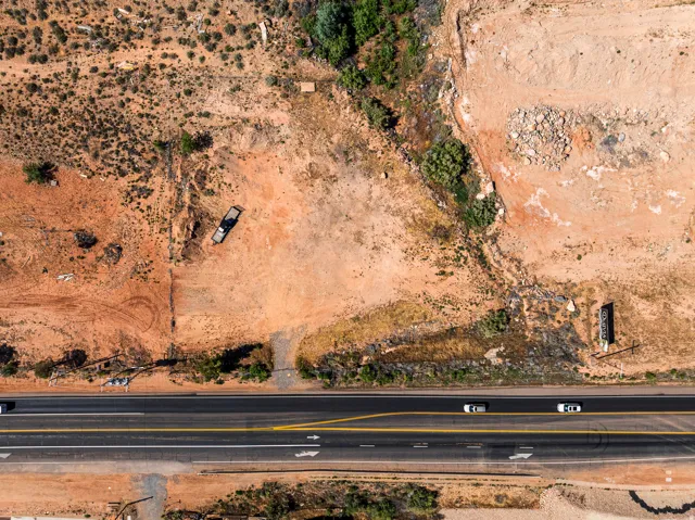 Expansive land parcel featuring direct road frontage and natural desert landscaping