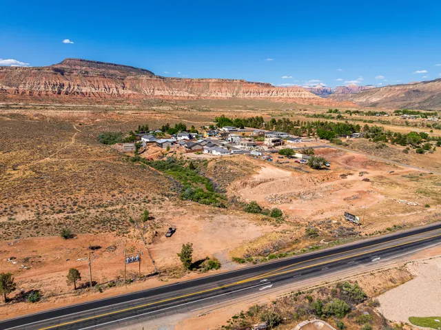 Expansive desert landscape with a paved roadway