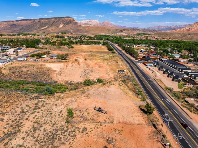 Expansive land parcel featuring direct highway frontage and mountain backdrop