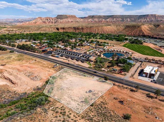 Expansive vacant land parcel situated alongside a paved road, offering direct access