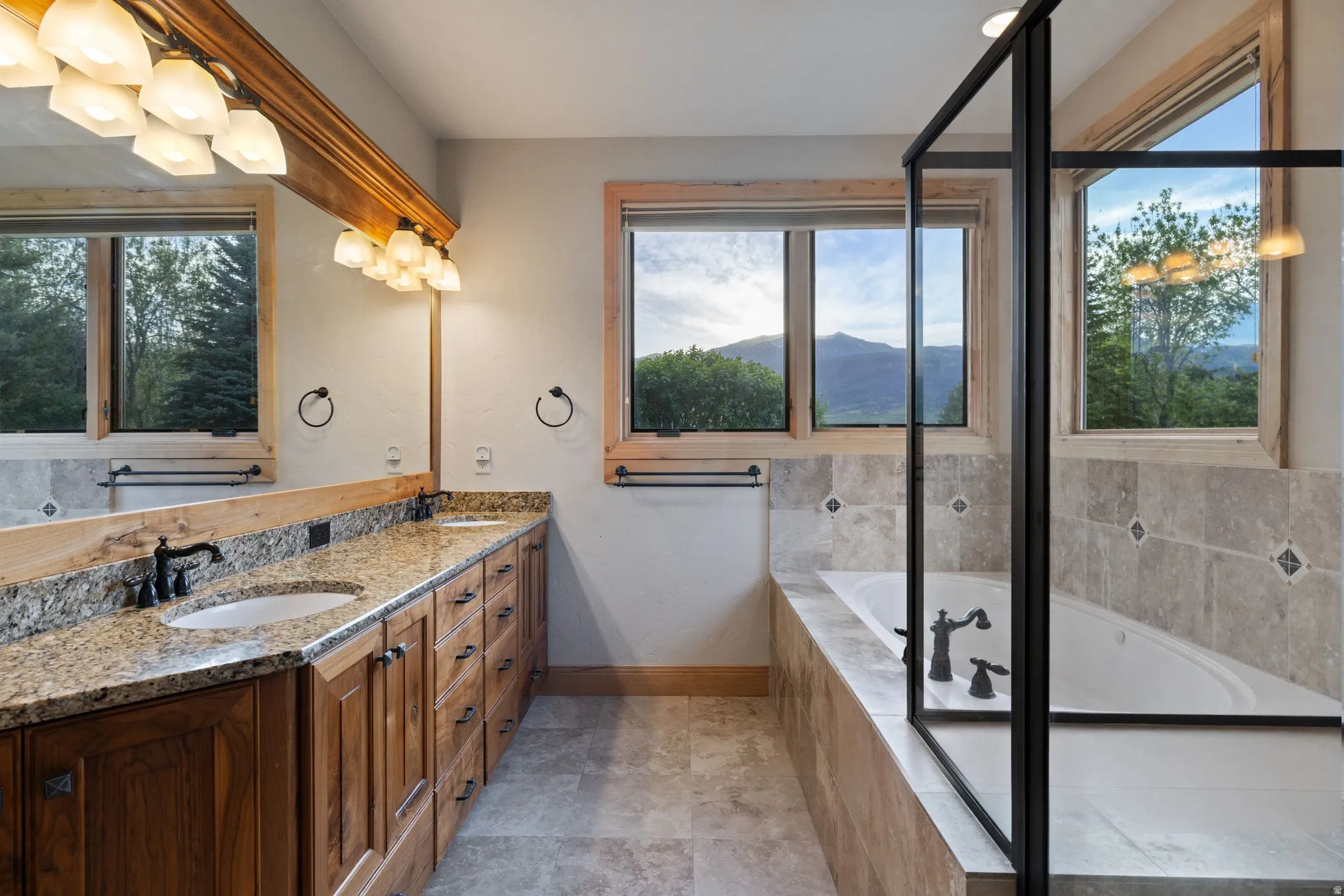 Bathroom with double vanity, a bath, and a shower stall
