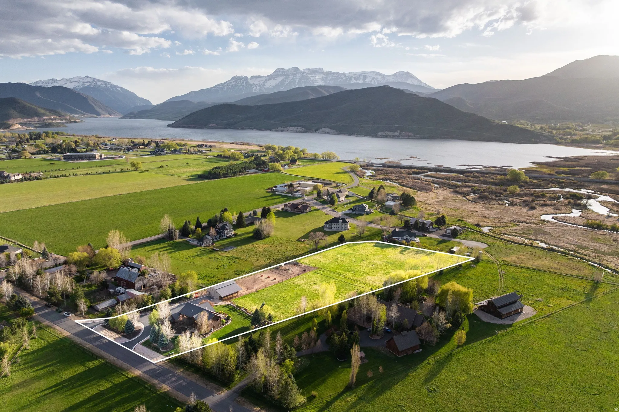 View of rural area with property parcel outlined and a water and mountain view