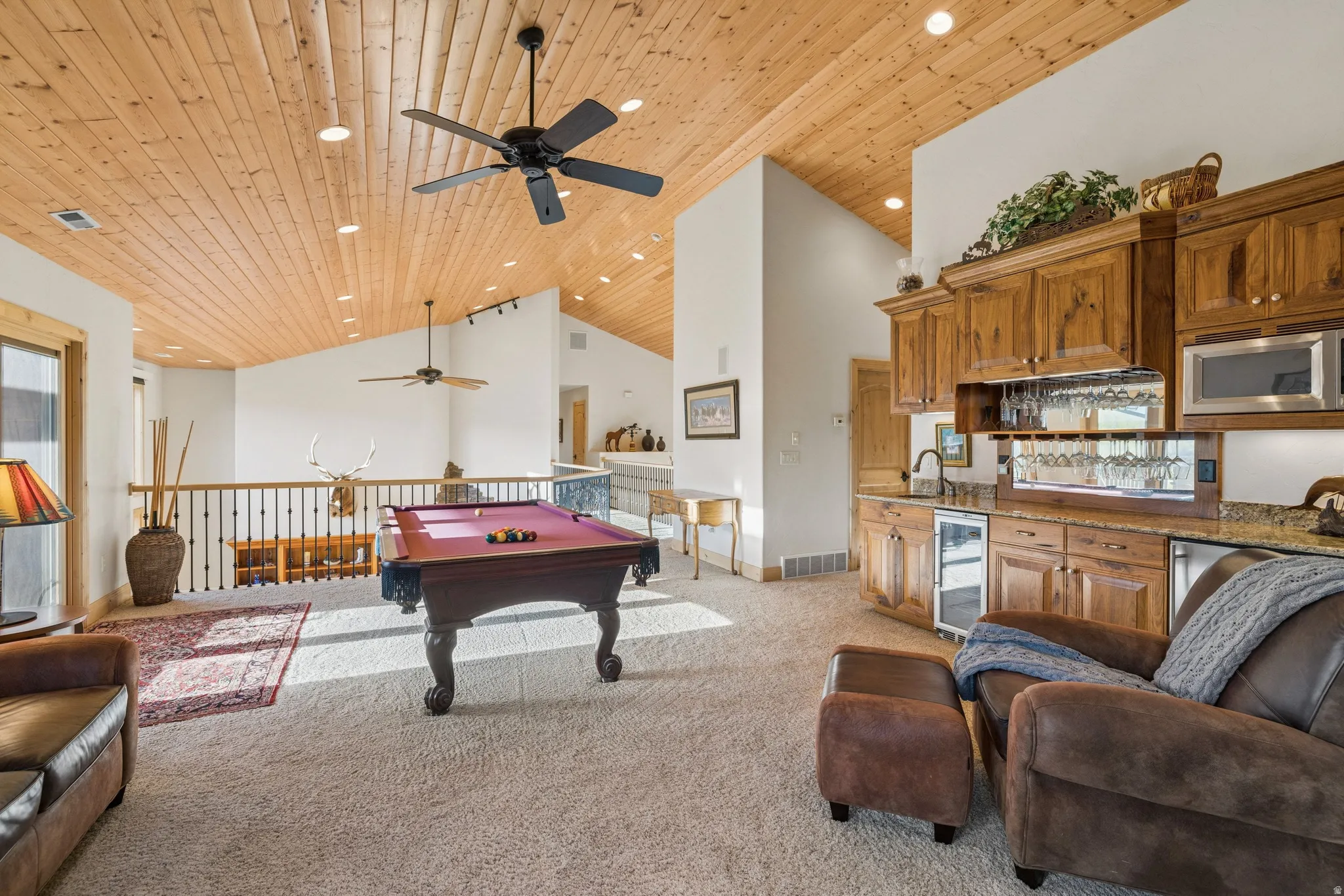 Game room with light carpet, a vaulted wood ceiling, a ceiling fan, billiards, and beverage cooler