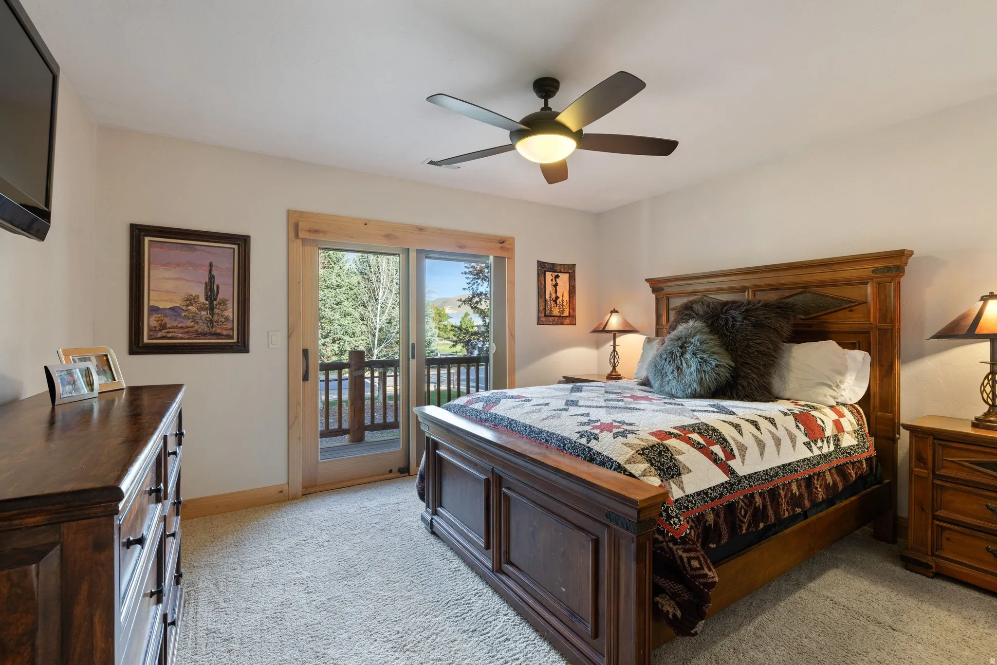 Bedroom featuring light colored carpet, access to exterior, and ceiling fan