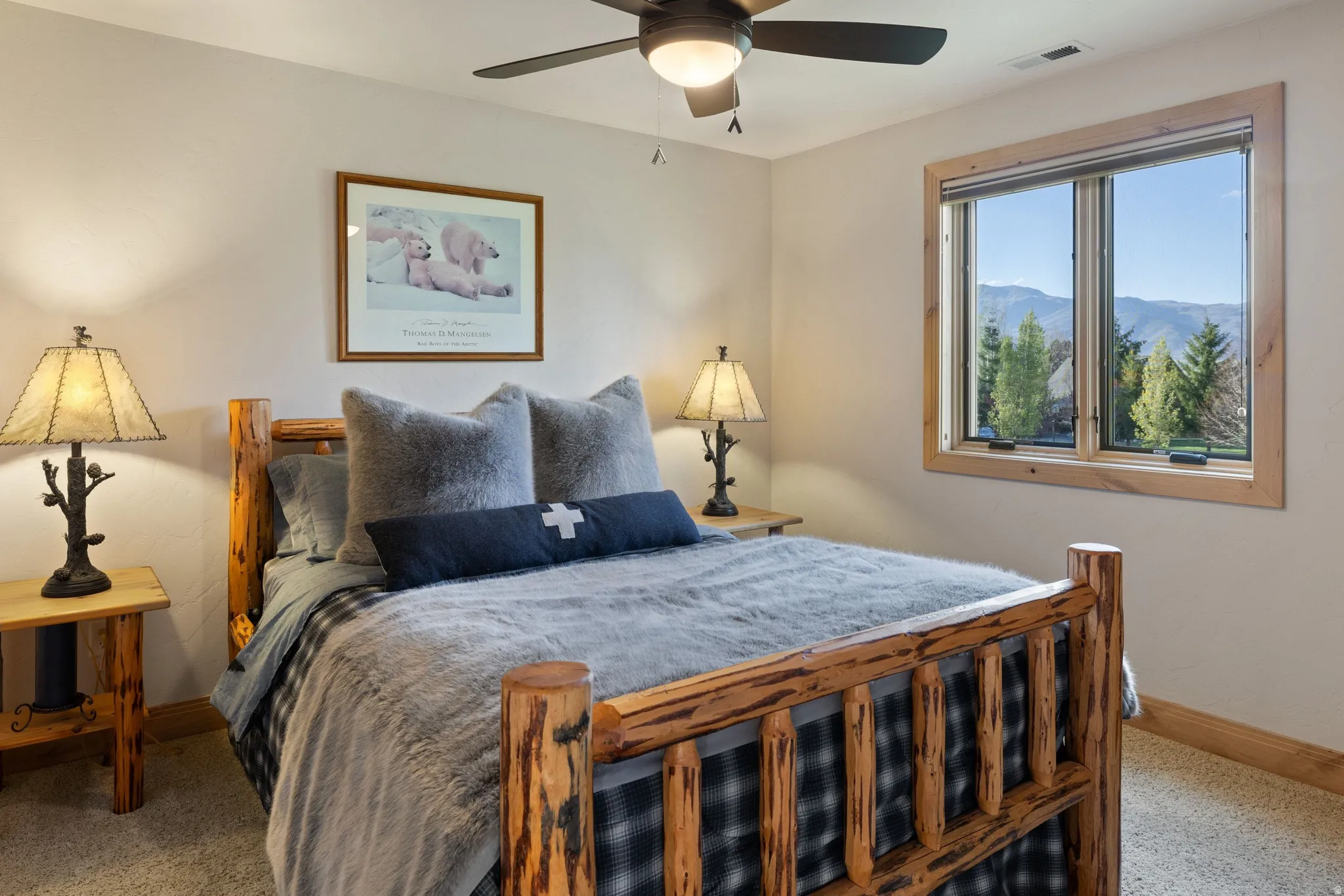 Carpeted bedroom with a ceiling fan and a mountain view