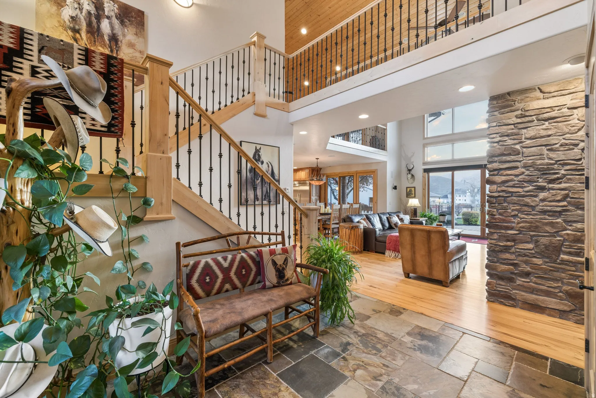 Stairway with a high ceiling, stone tile flooring, and recessed lighting