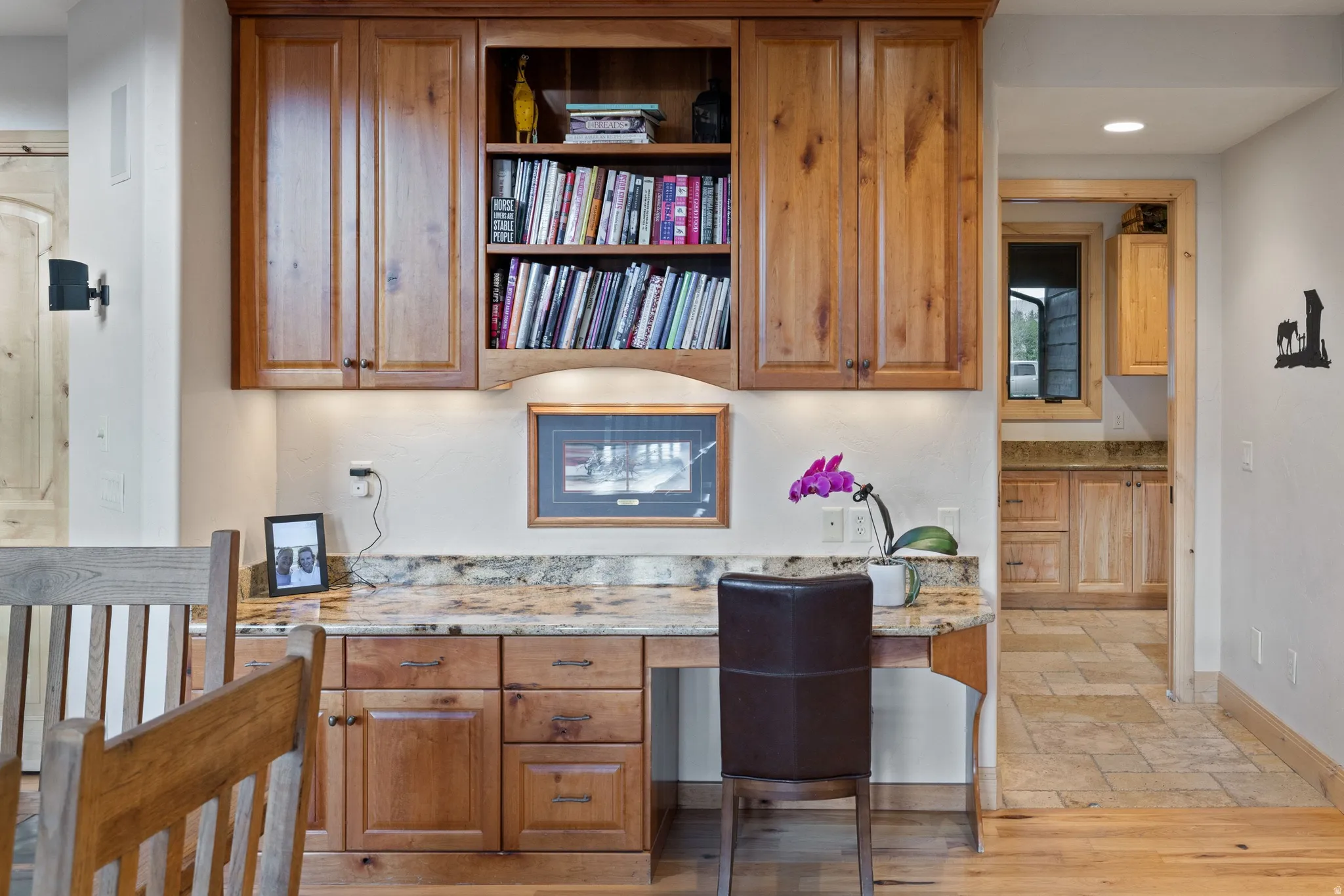 Home office with built in study area, recessed lighting, and stone tile flooring