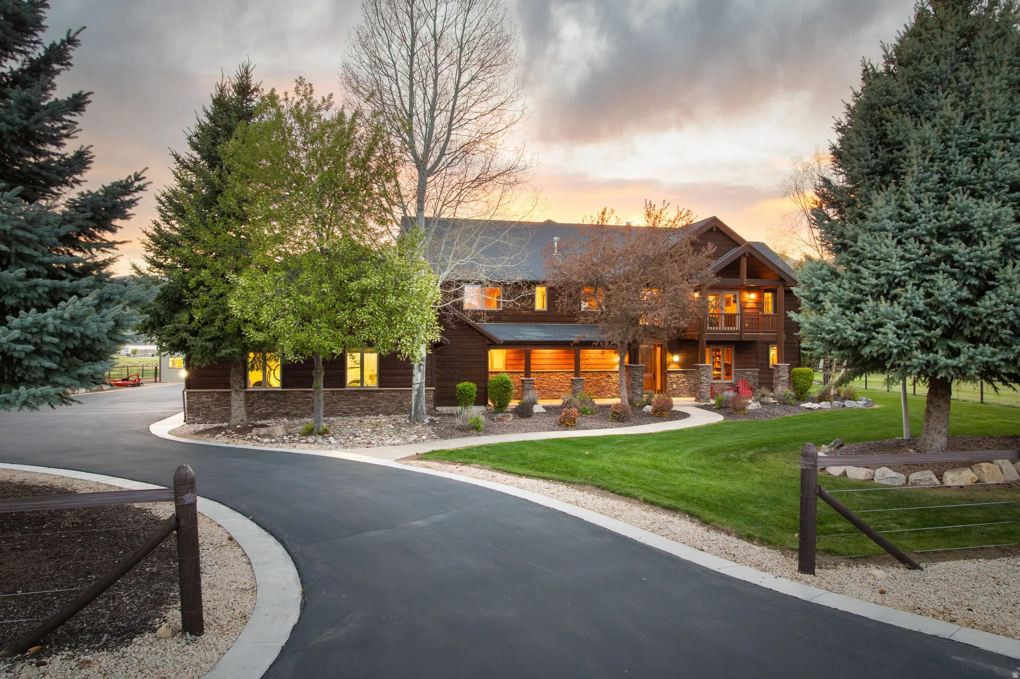 View of front of property with a lawn, stone siding, and a porch