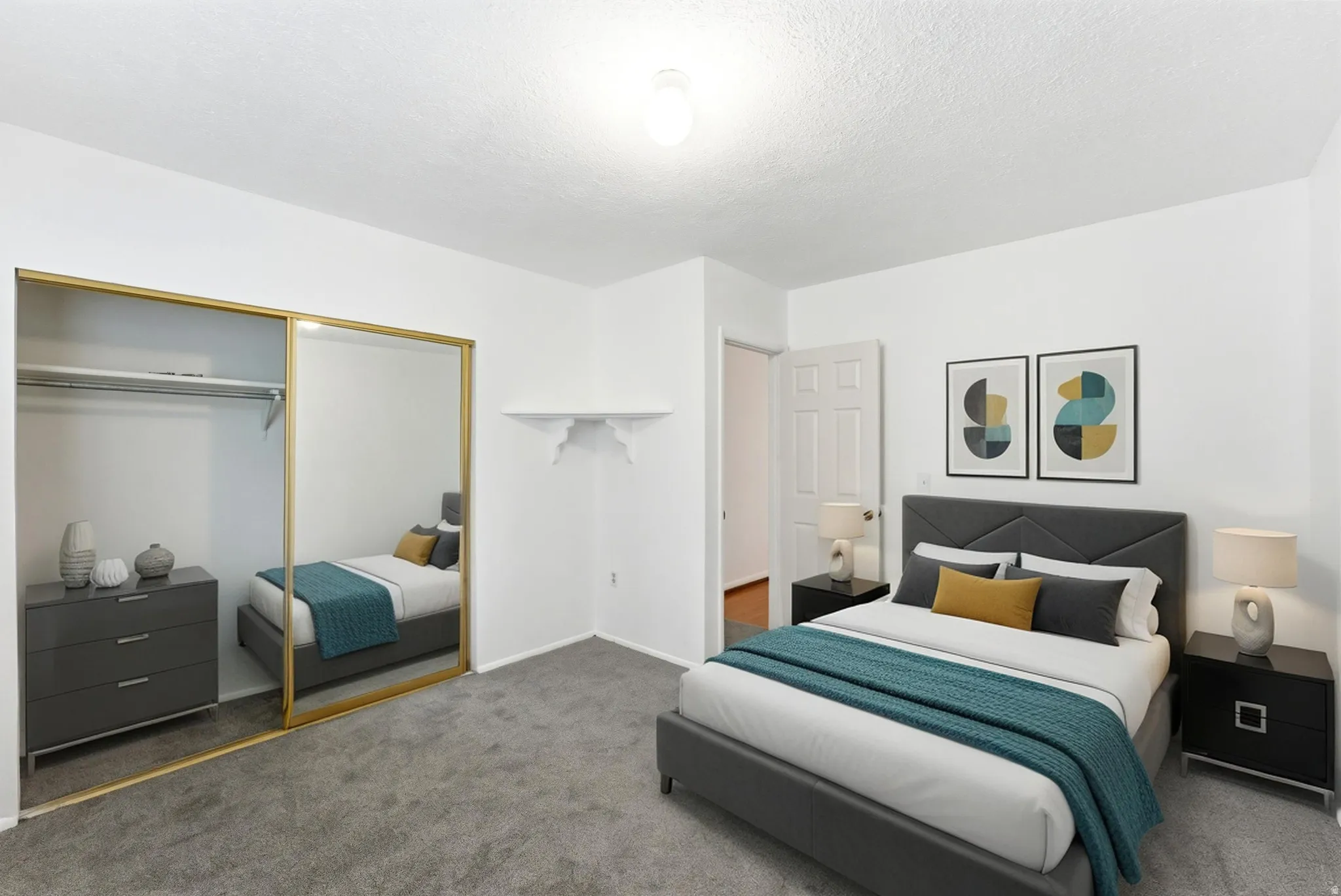 Carpeted bedroom featuring a mirrored sliding closet door, overhead ceiling light fixture, white interior door, and white walls