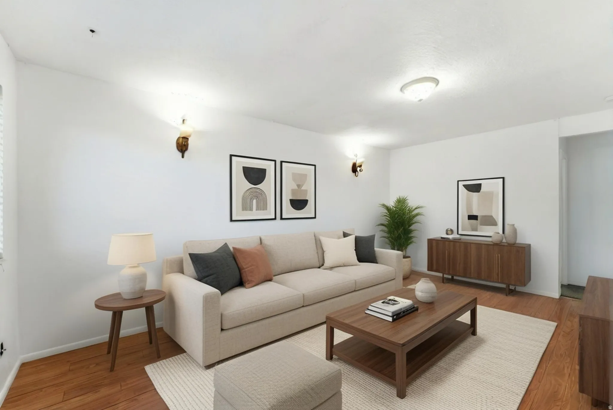 Living area featuring wood-finish flooring, white walls, and recessed lighting