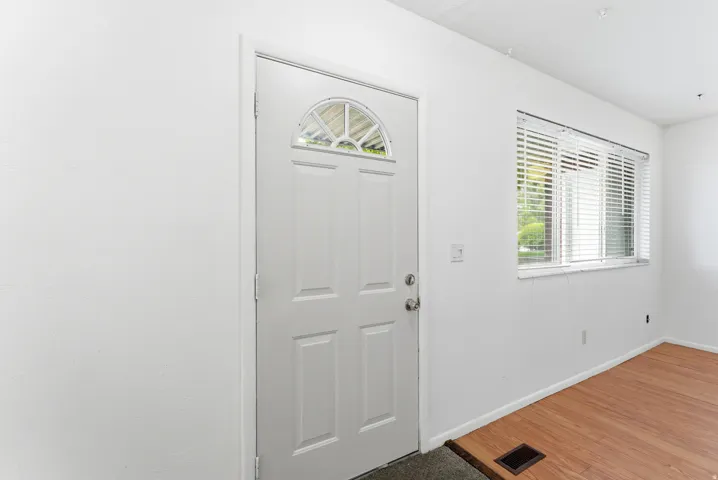 Entry door featuring a decorative arch window