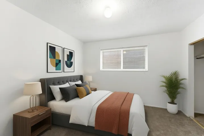 Bedroom featuring a window with horizontal blinds, overhead ceiling light, and carpet flooring