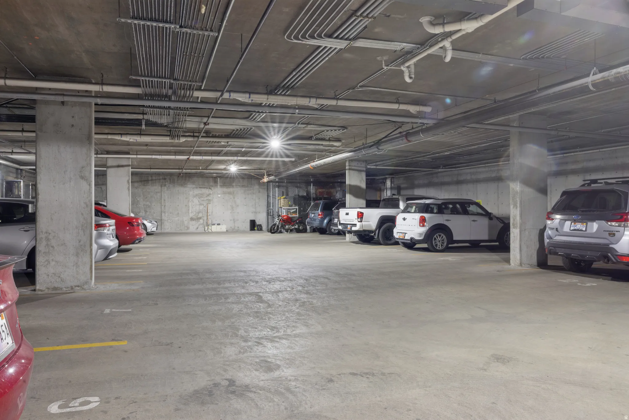 Underground parking garage featuring concrete pillars and ceiling