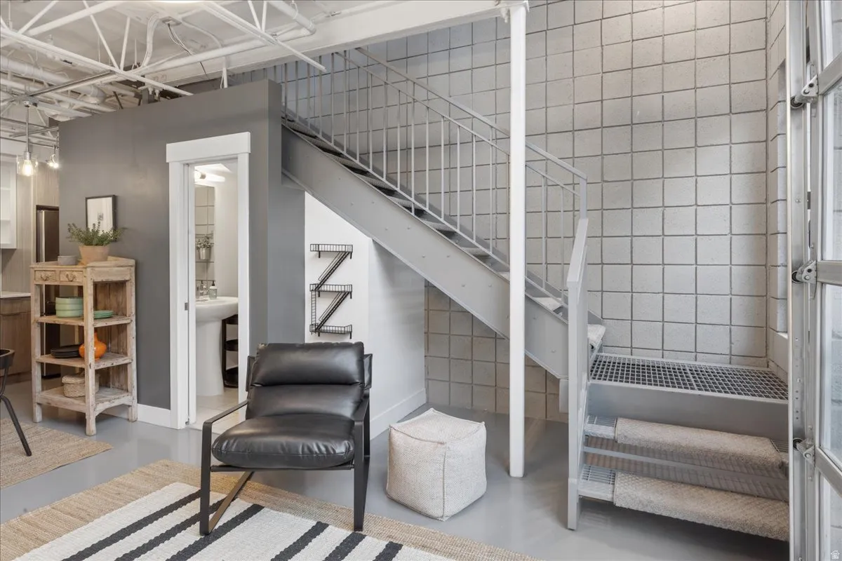 Industrial-style metal staircase with perforated treads and a matching railing
