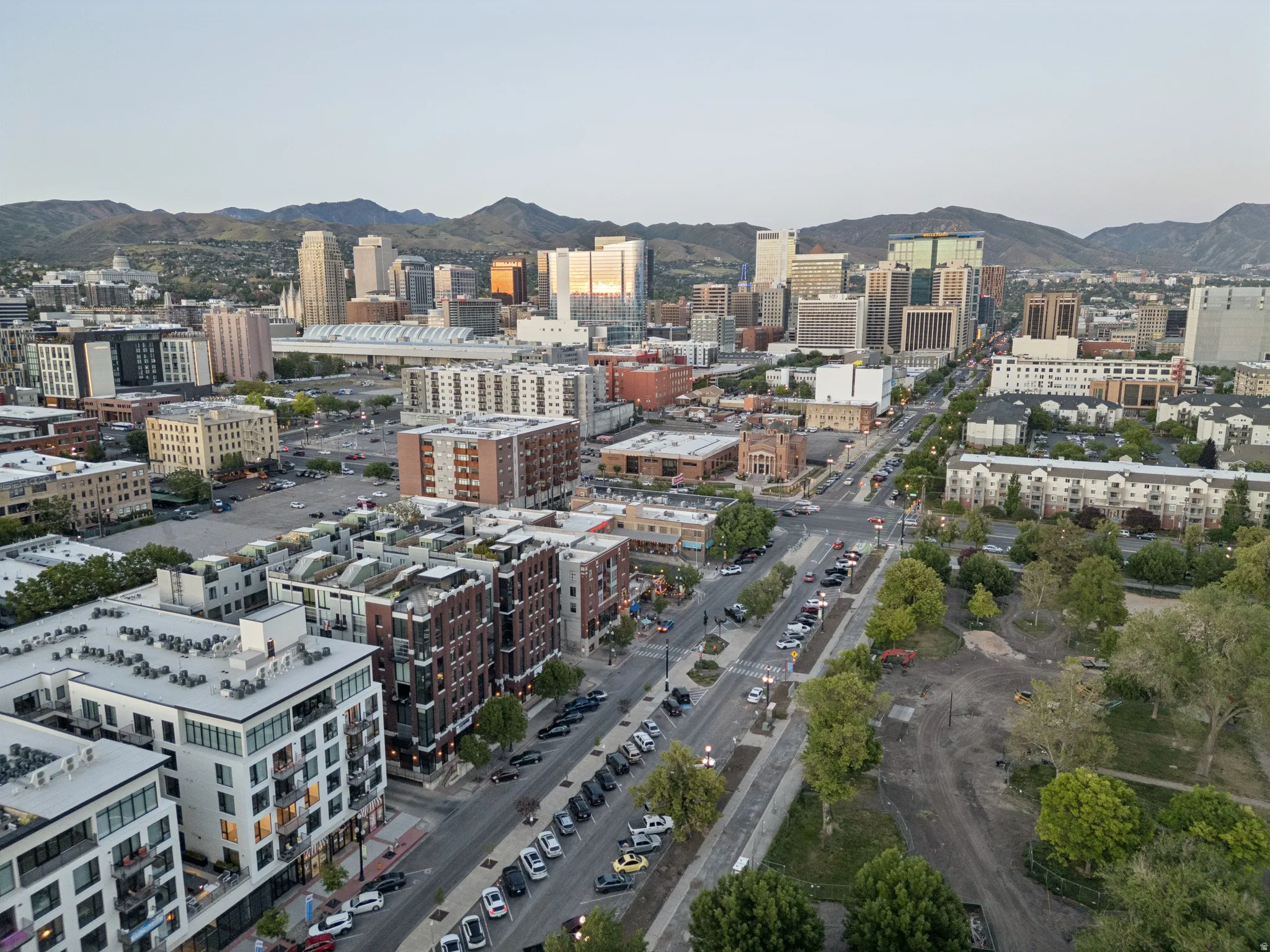 Expansive urban panorama featuring a diverse architectural landscape with mountains in the background