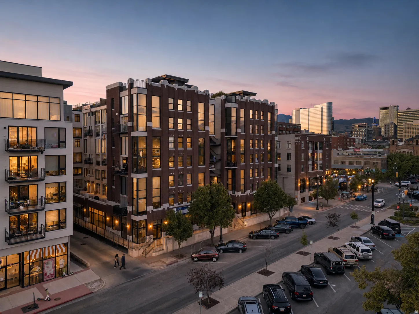 Contemporary multi-story building featuring multiple balconies with metal railings, extensive window placements, and a flat roofline