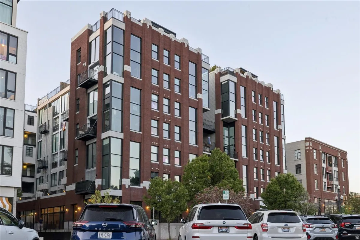 Multi-story building featuring a red brick facade with prominent vertical window arrays