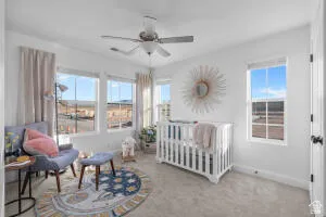 Bright room featuring a ceiling fan, white trim, and multiple windows