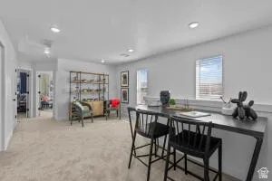 Spacious upper-level room featuring light-toned carpeting and recessed lighting