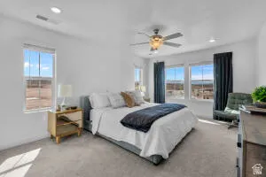 Spacious room featuring multiple windows, recessed lighting, and a ceiling fan