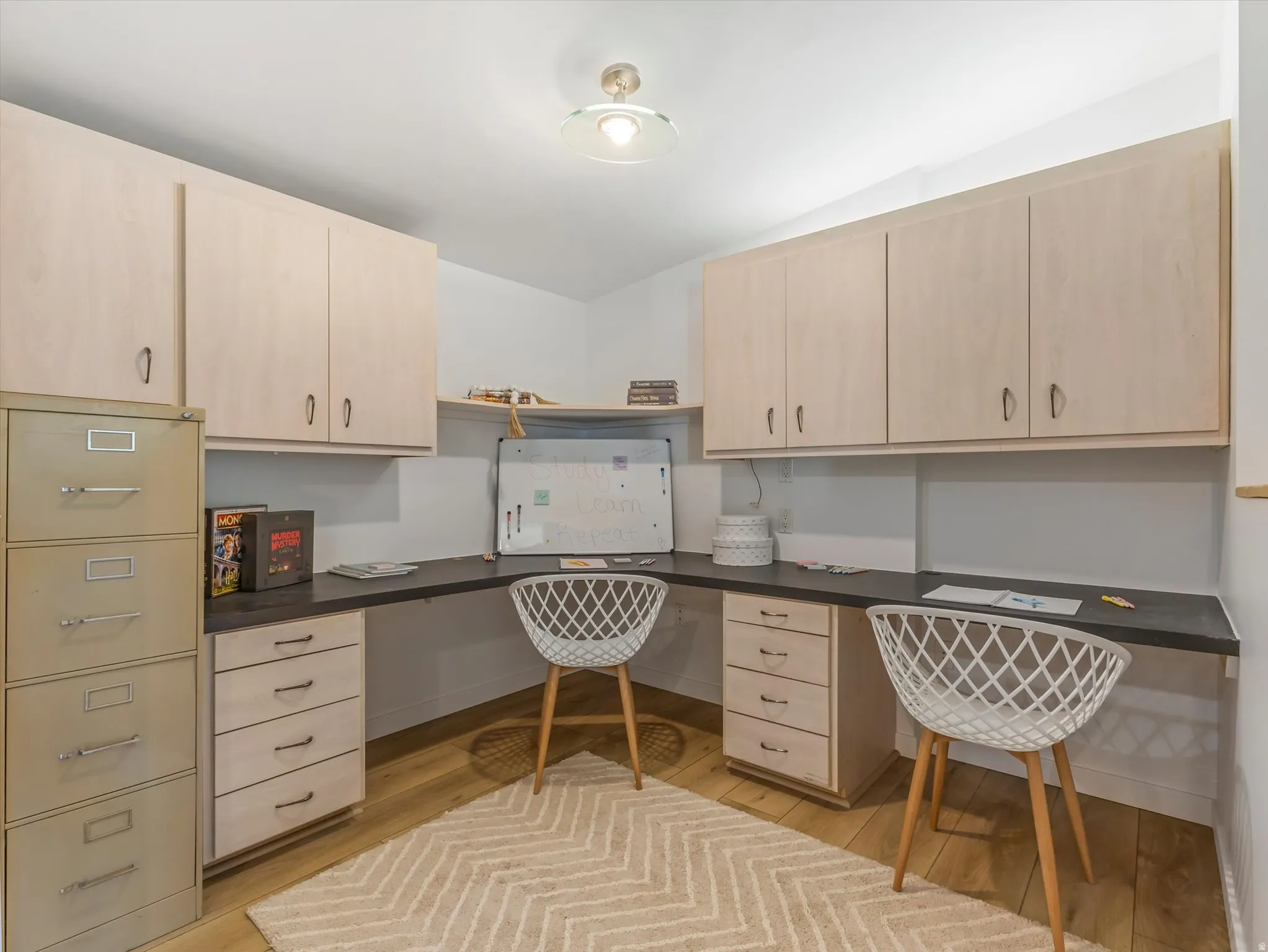 Dedicated workspace featuring custom built-in cabinetry.