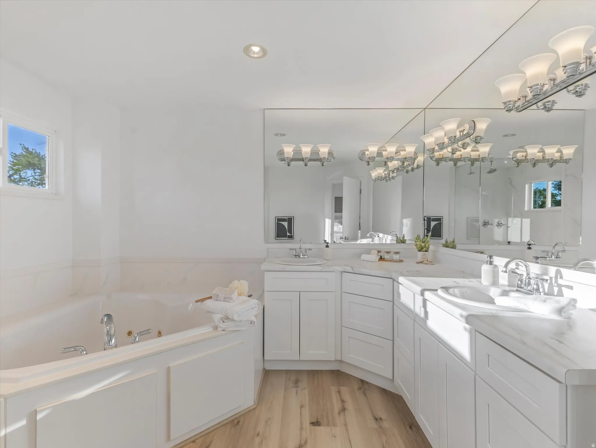 Primary En-Suite featuring a spacious corner soaking tub and a glass-enclosed shower with dual rainfall showerheads