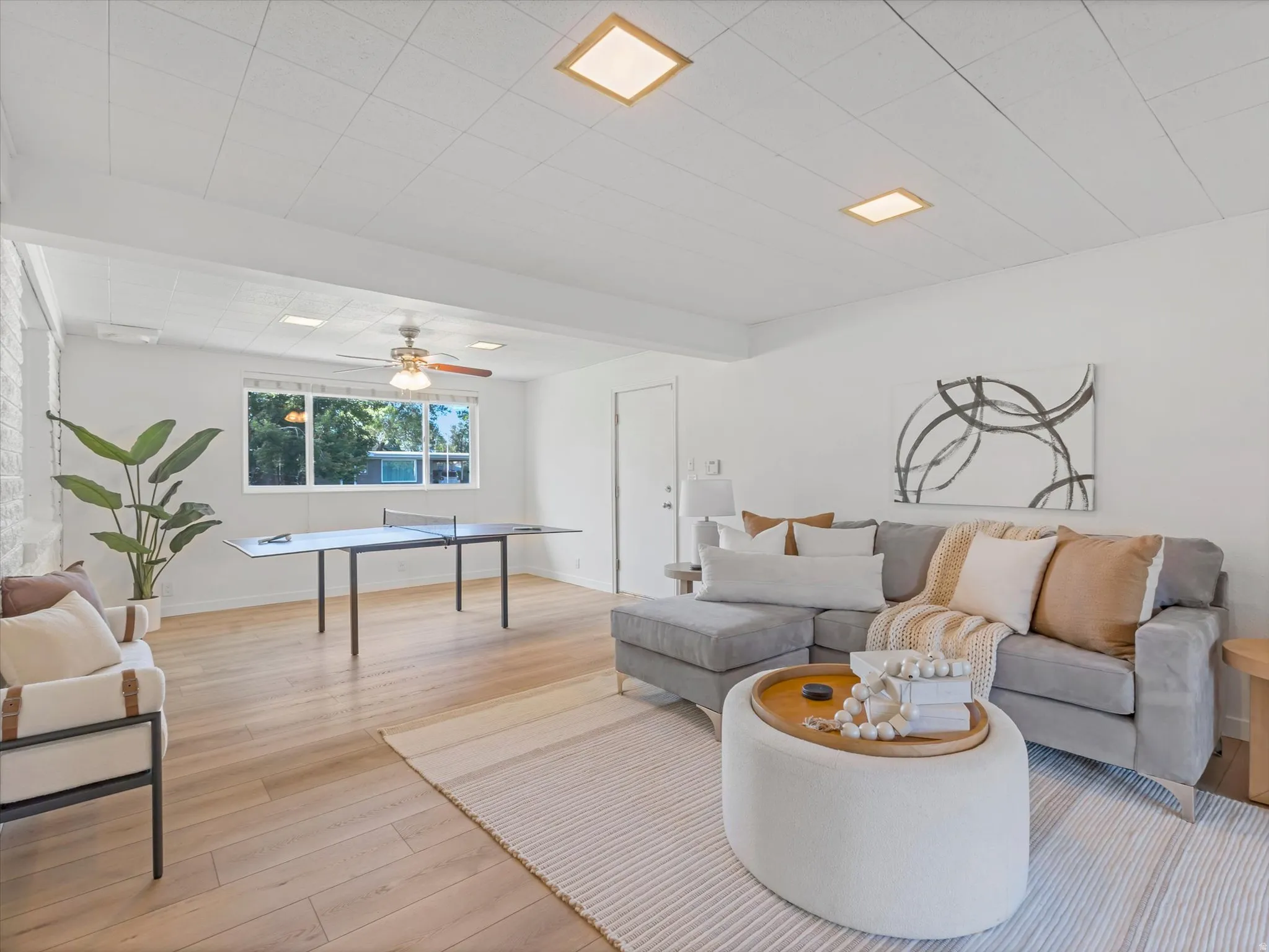Spacious bonus room featuring wood-finish flooring, a ceiling fan, recessed lighting, and a large window