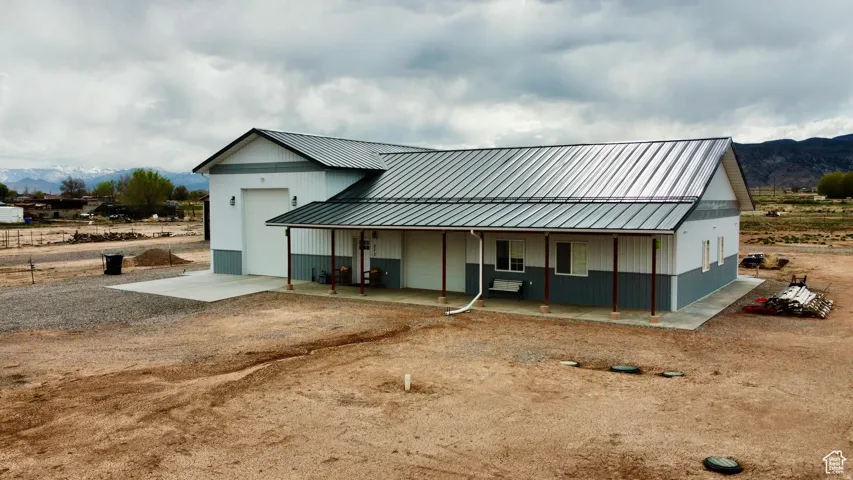 Contemporary exterior featuring a two-tone facade with a gray metal roof