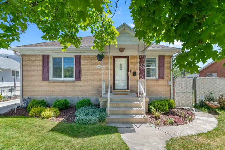 Brick exterior with a covered front porch and concrete steps