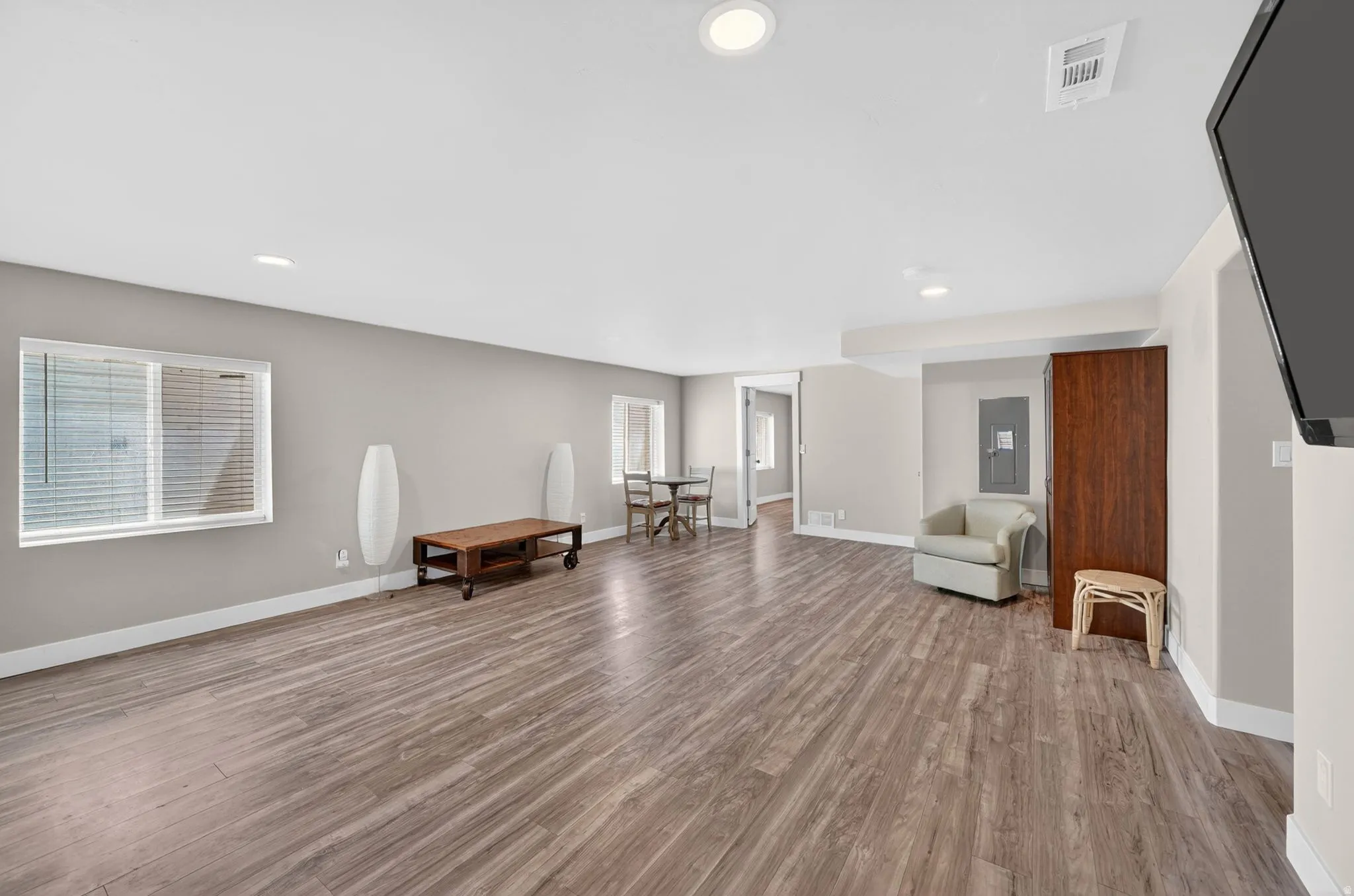 Spacious interior featuring wood-finish flooring, recessed lighting, and light-toned wall paint