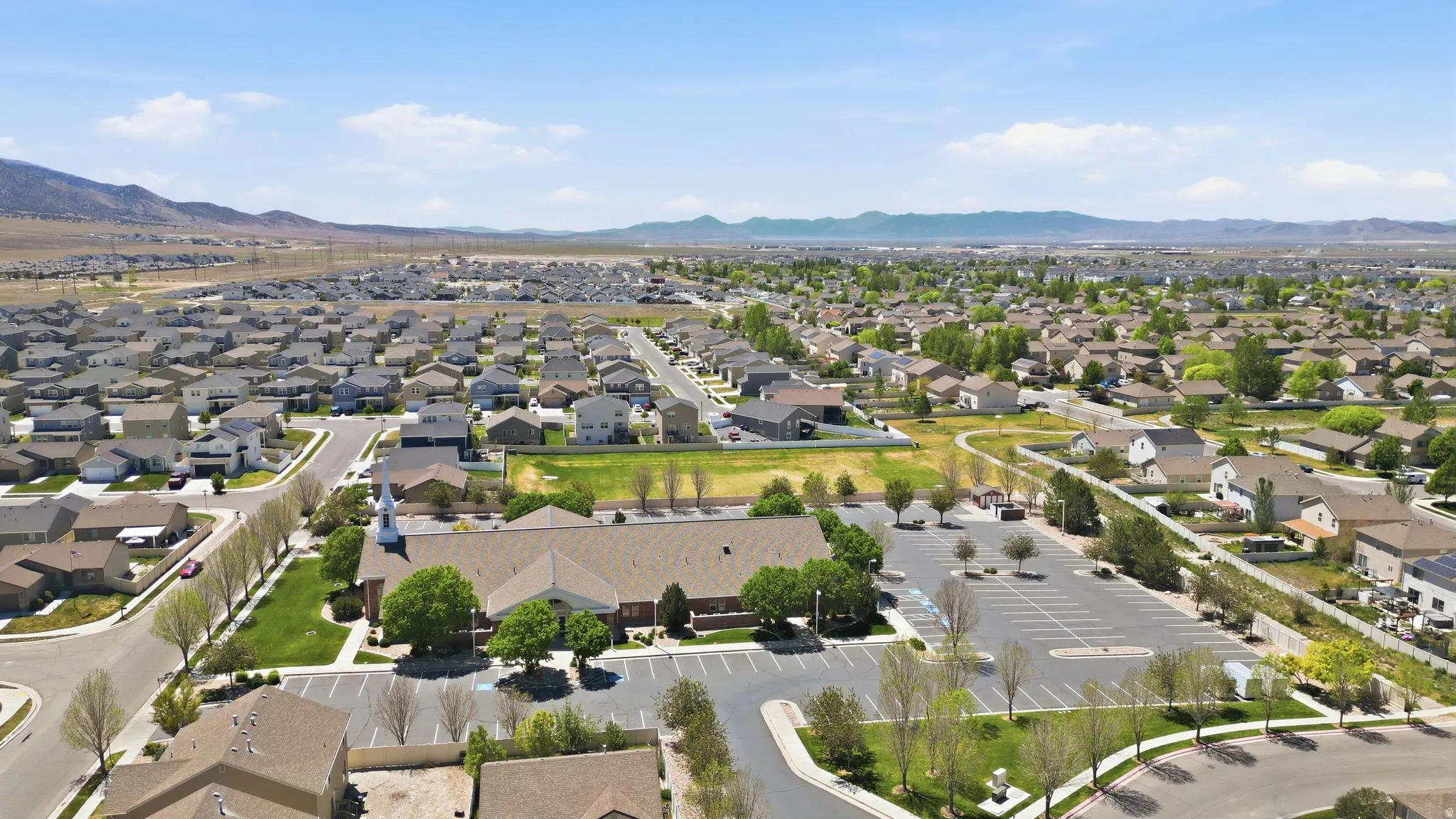Expansive suburban landscape featuring numerous residential properties and a large parking area