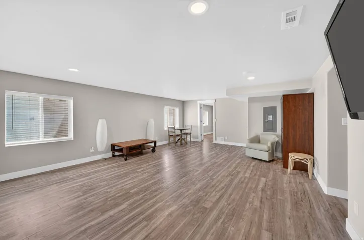 Spacious interior featuring wood-finish flooring, recessed lighting, and light-toned wall paint