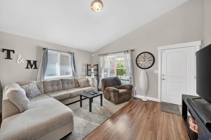 Living area featuring high vaulted ceilings and light gray wall paint