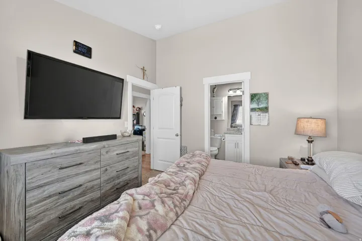 Bedroom featuring light neutral wall tones and wood-finish flooring