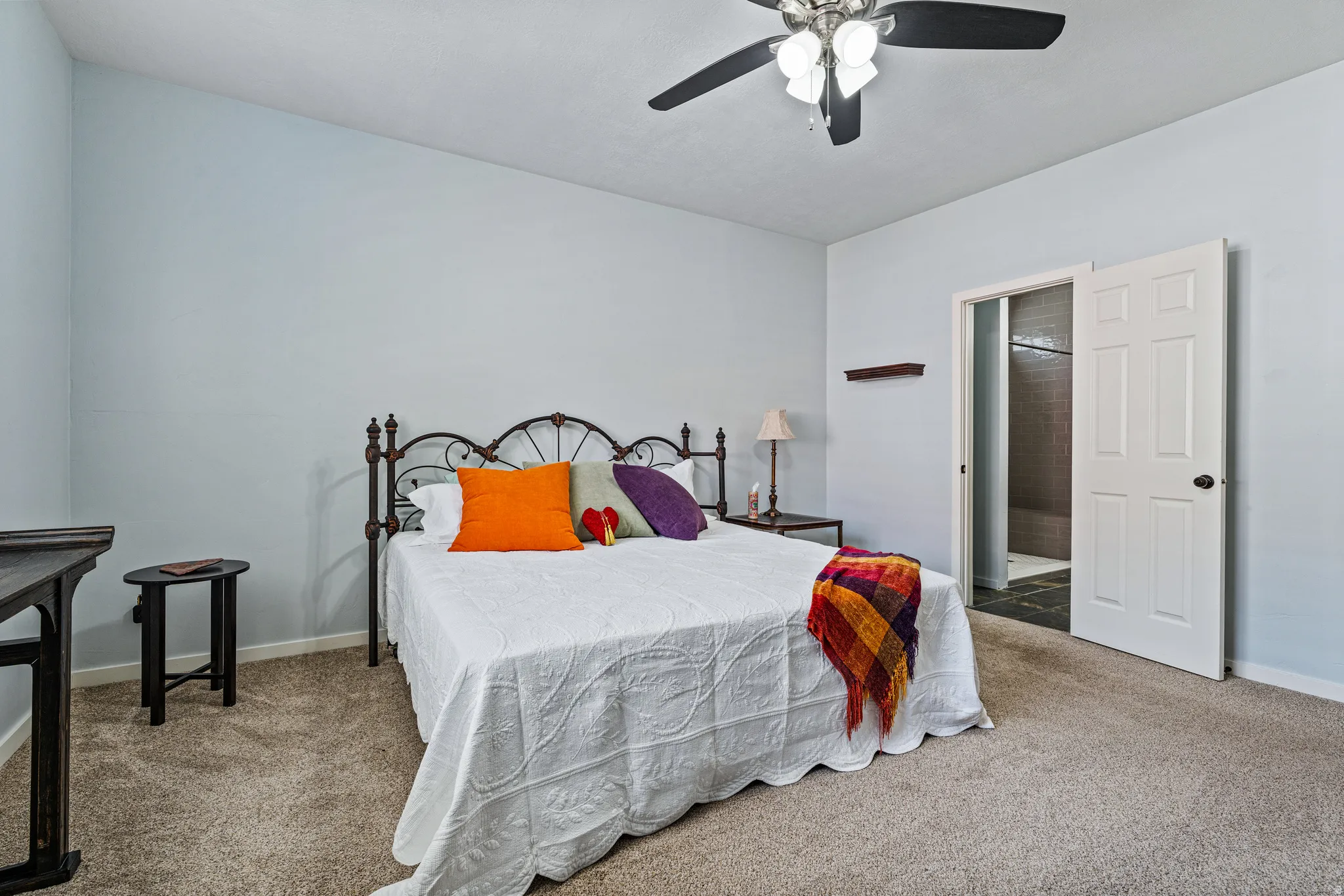 Carpeted room featuring light blue walls and a ceiling fan with integrated lighting