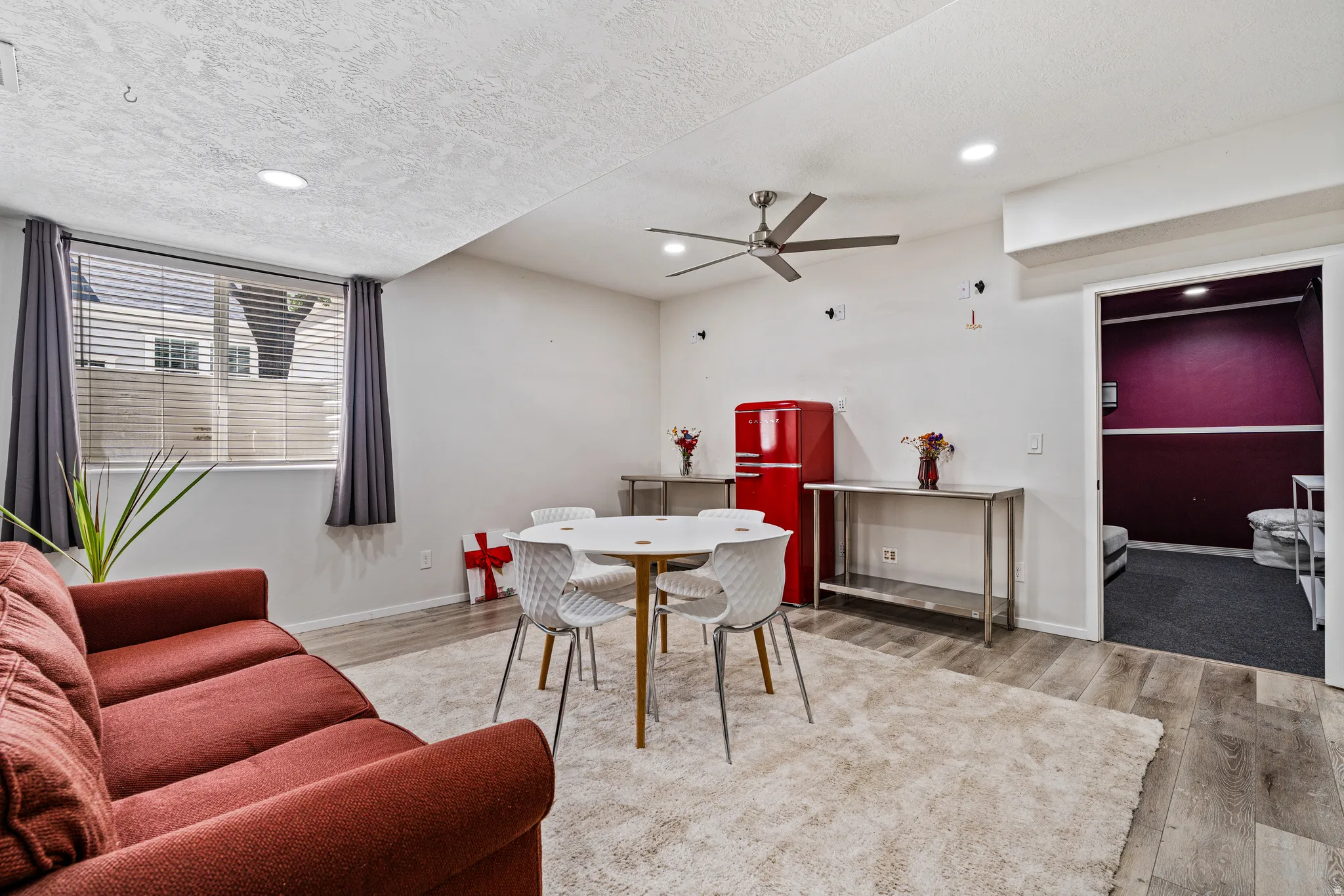 Bright room with wood-finish flooring, recessed lighting, and a ceiling fan
