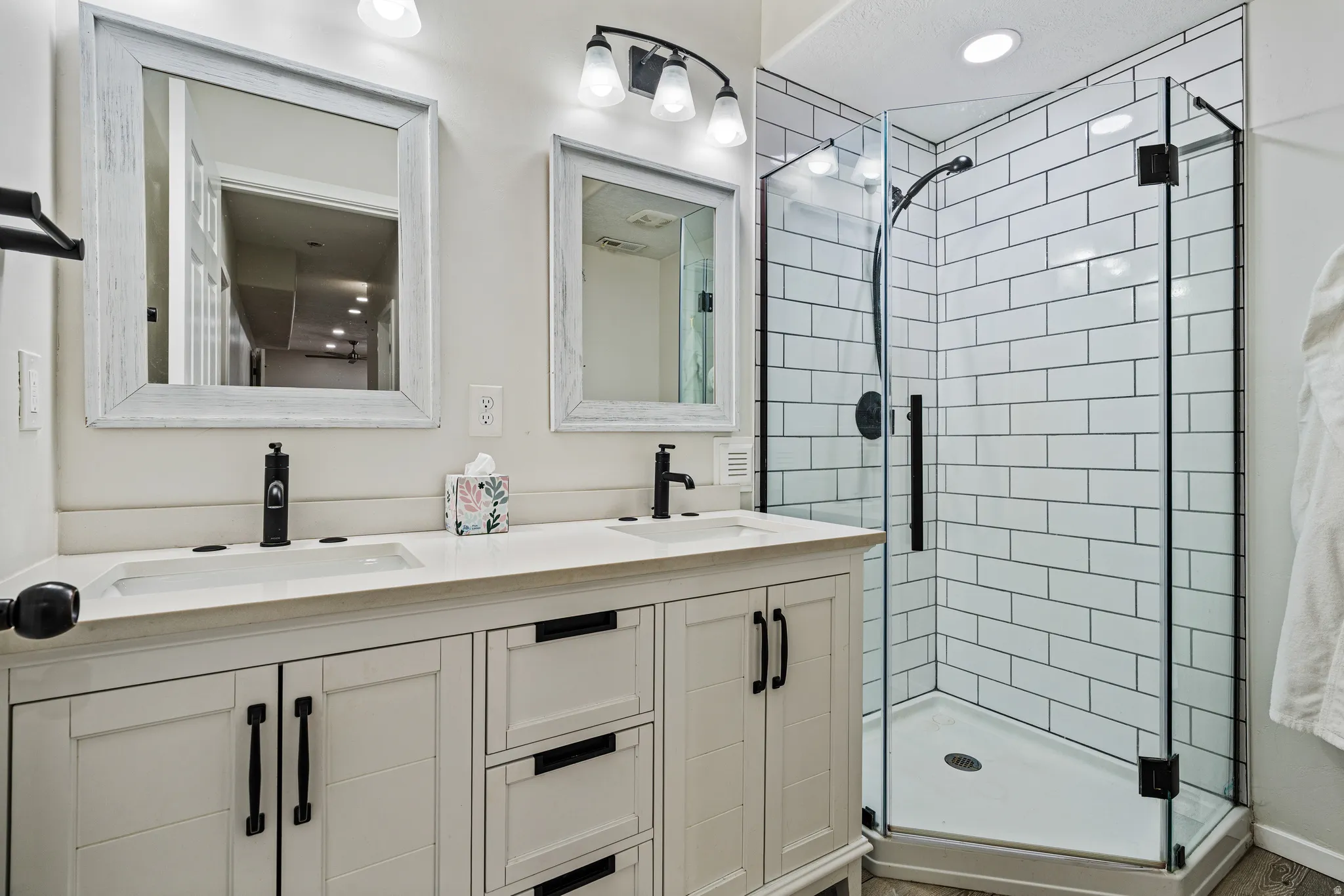 Dual vanity with matte black fixtures and light-colored countertops