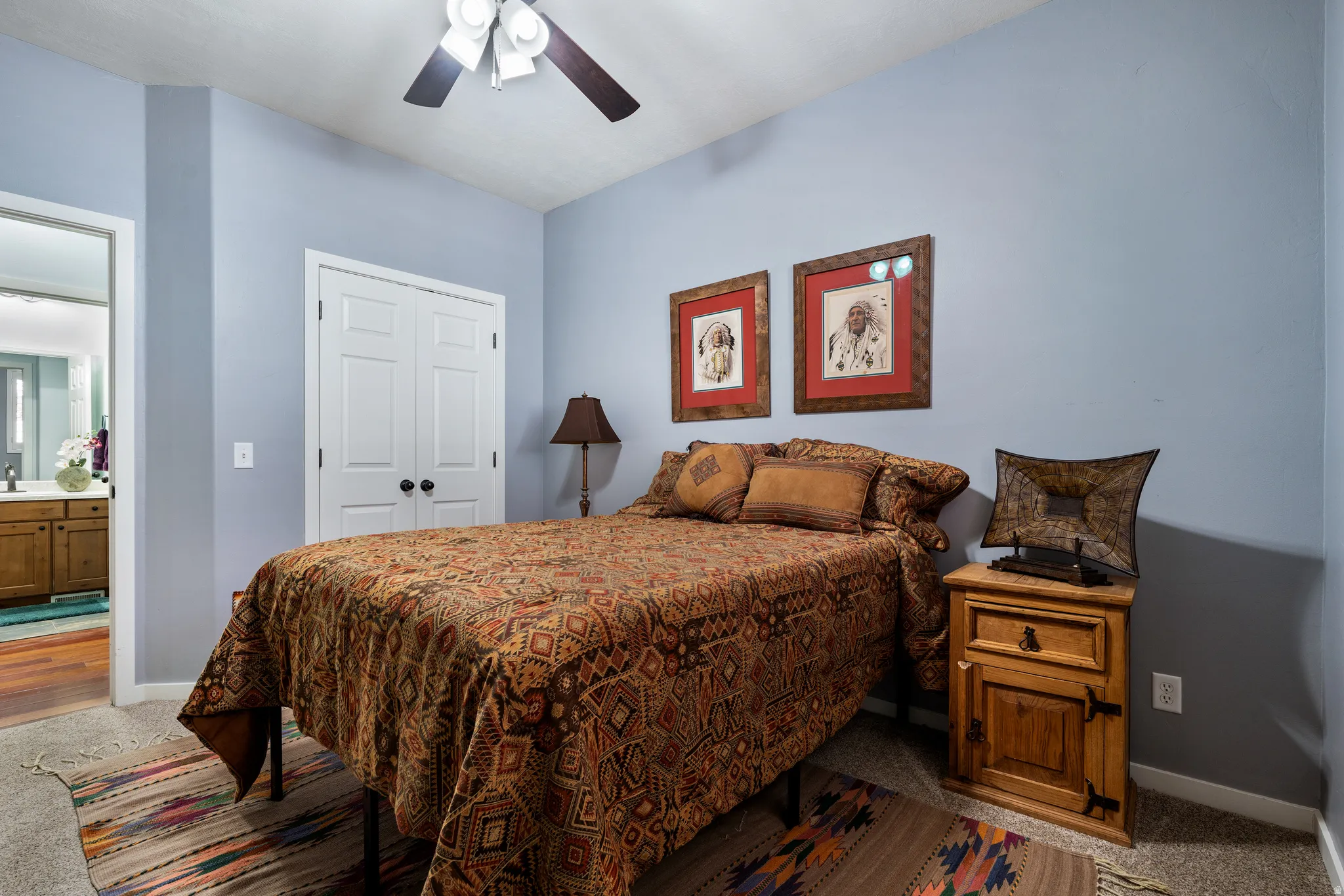 Bedroom featuring light blue walls and a vaulted ceiling